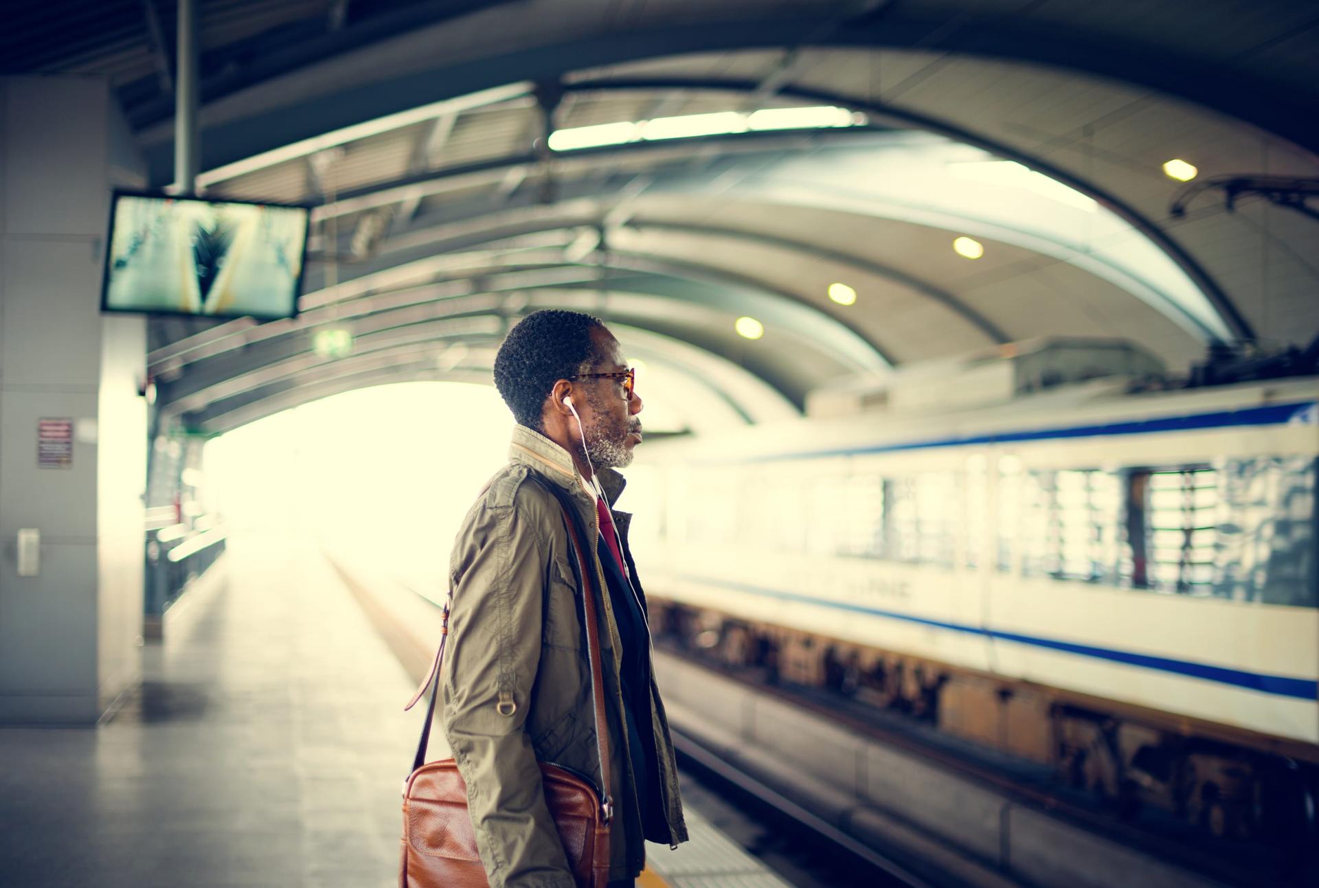 A man waiting on a train station platform