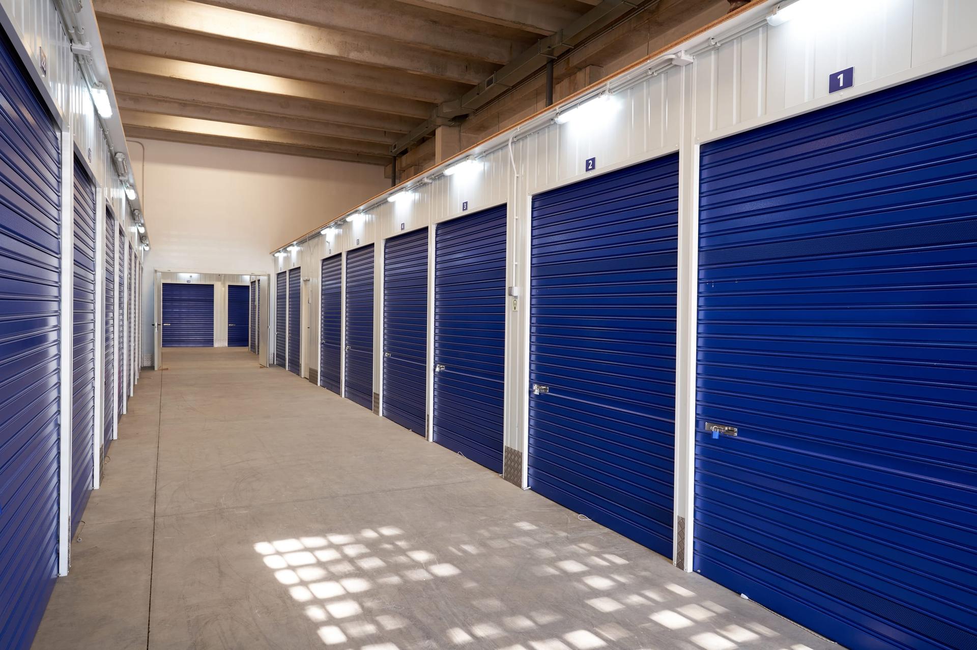 Corridor of self-storage units with roll-up doors