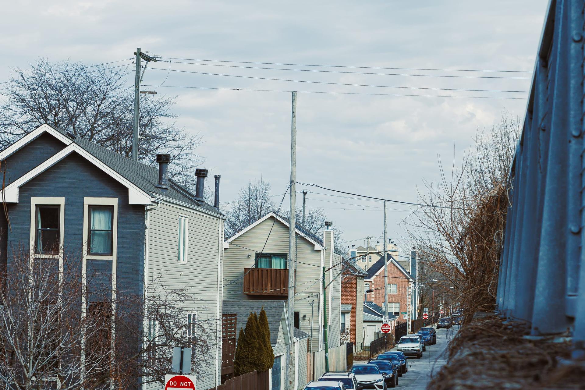 A residential street of detached houses on an overcast day